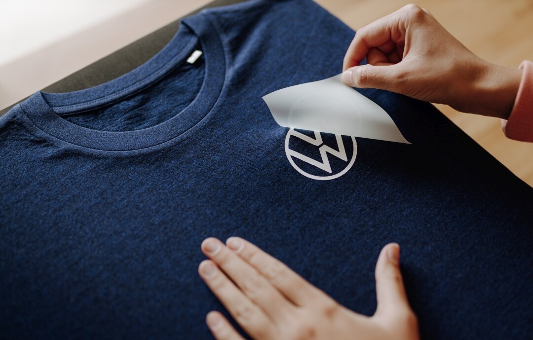Weißes Logo wird per Flexdruck auf blaues T-Shirt veredelt
